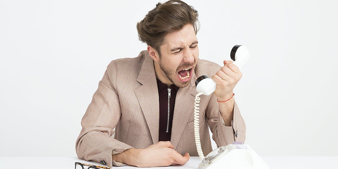Man screaming into a telephone
